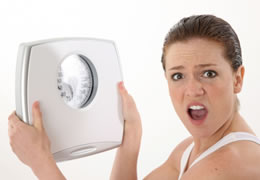 Picture of a woman holding weight scale