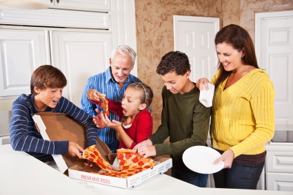 Family eating pizza from take-out box