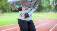 image of female runner in pain from side stitches