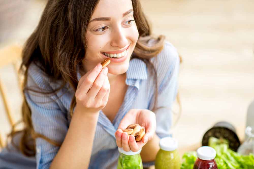 image of a woman eating nuts