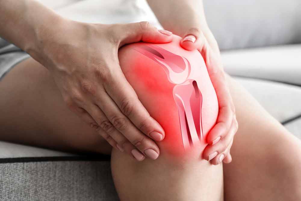 image of person holding their knee from pain due to osteoarthritis