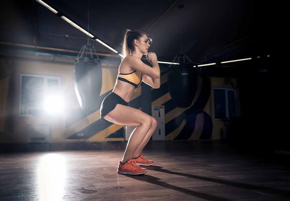 image of a woman squatting without weights working on her hip mobility