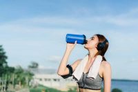 image of woman drinking an exercise recovery drink after working out