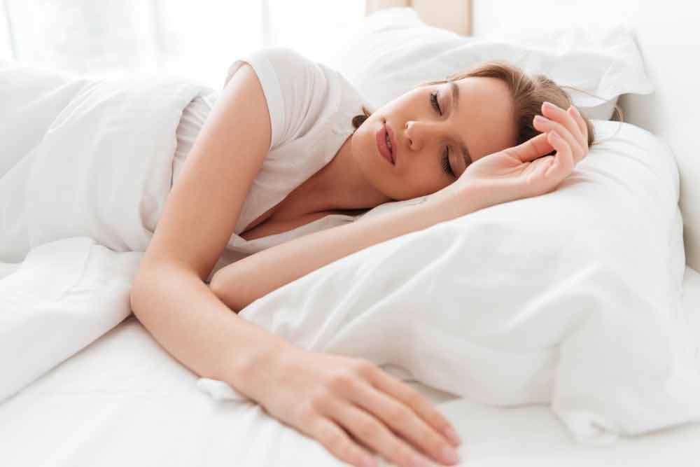 image of woman in bed in deep sleep