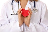 image of a woman doctor holding a red heart