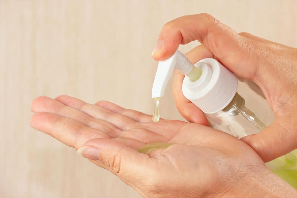 image of Female hands applying some different hand sanitizers 