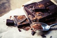 image of dark chocolate over wooden background