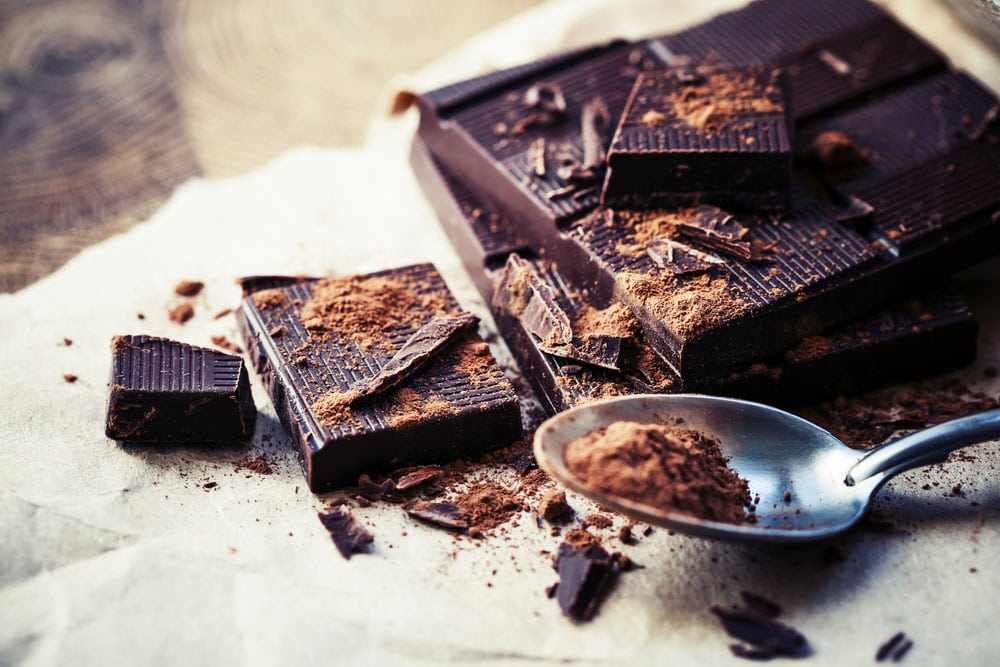 image of dark chocolate over wooden background. Did you know dark chocolate can help to increase your exercise endurance?