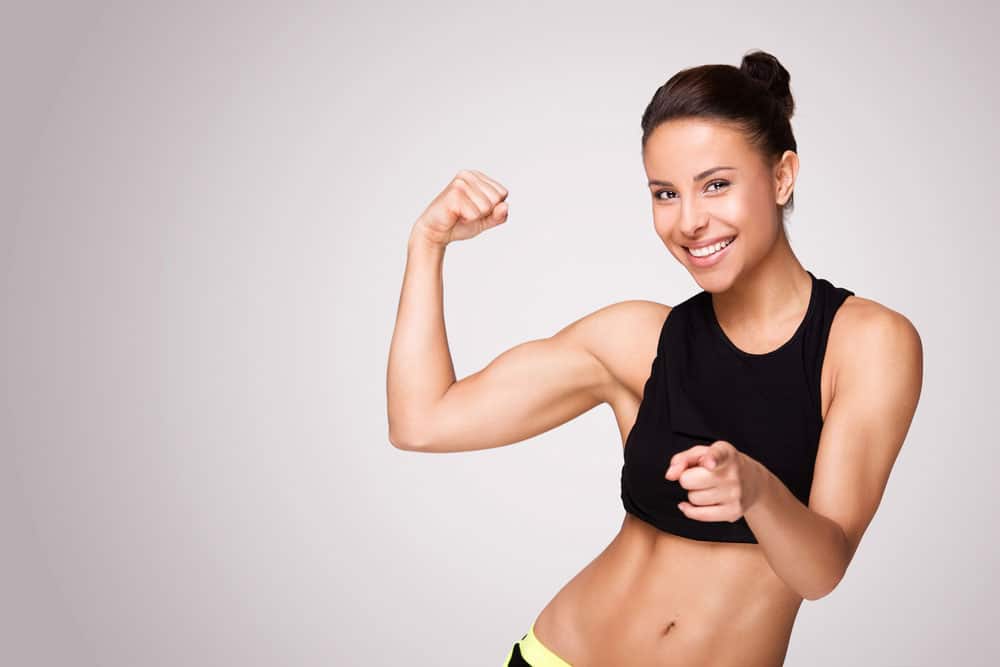 image of a young woman showing her biceps muscles