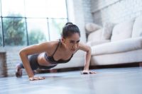 image of a woman doing a push up in her living room
