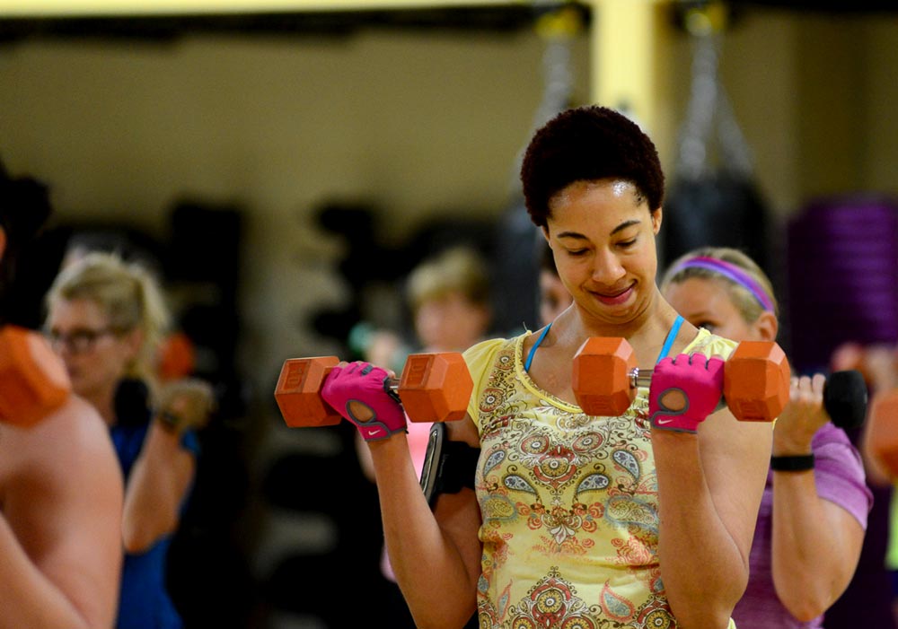 image of a Cathlete using dumbbells to get fit