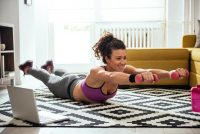 image of a young woman exercising at home her living room not letting mental blocks stop her from working out