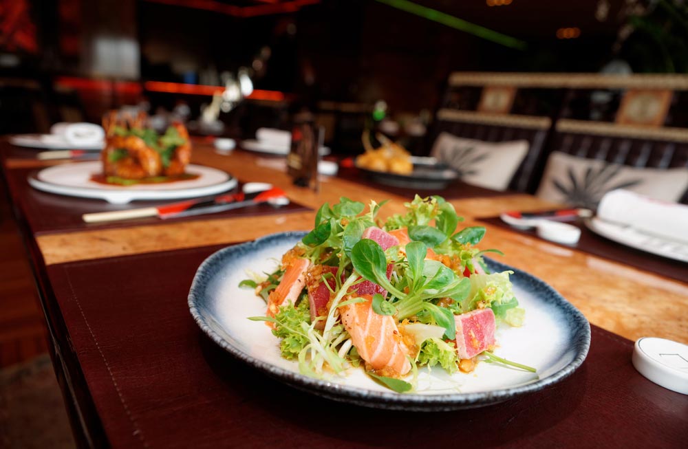 image of an appetizer with rare fried tuna and salmon on restaurant table