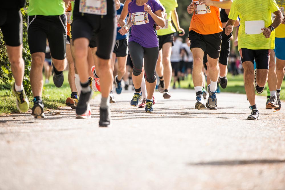 image of group of unrecognizable runners outdoors. Long distance running.