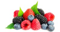 image of close-up arrangement mixed, assorted berries including blackberries, strawberry, blueberry, raspberries and fresh leaf isolated on white.