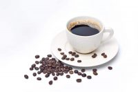 image of white cup of coffee and coffee beans on white background