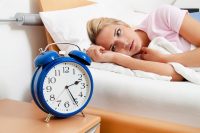 A woman having a problem sleeping. Can lack of sleep increase the risk of a training injury?