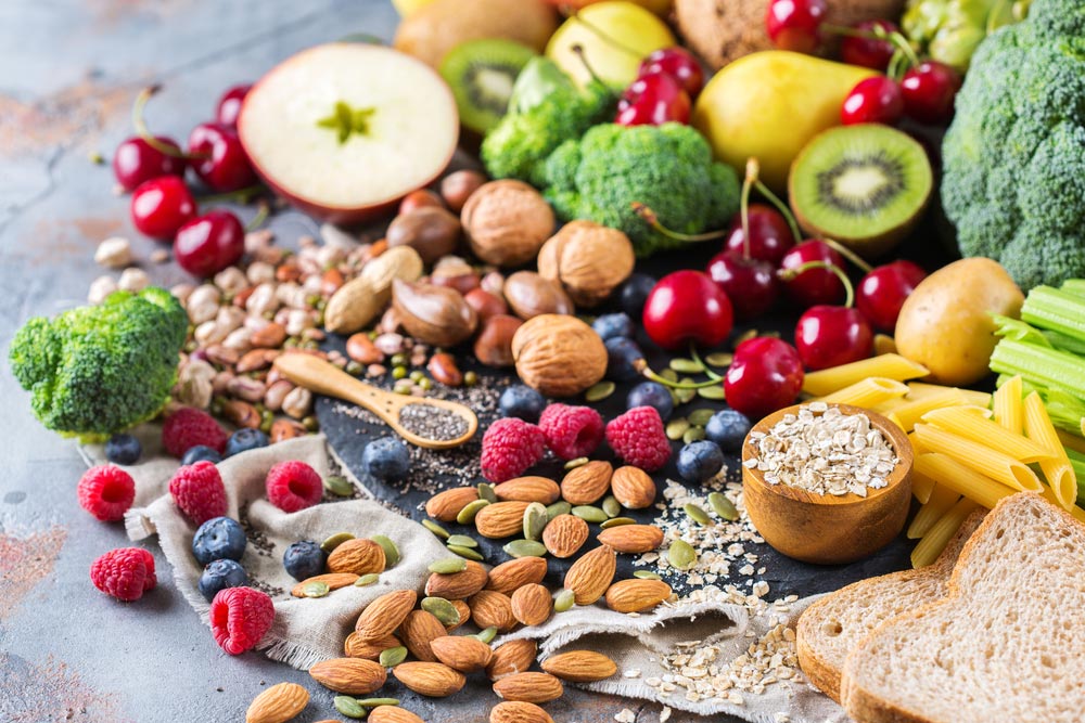 Selection of rich fiber sources vegan food. Vegetables fruit seeds beans and other excelelnt sources of viscous fiber an soluble and insoluble dietary fiber.