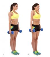 A woman doing dumbbell shoulder shrugs to strengthen her traps.