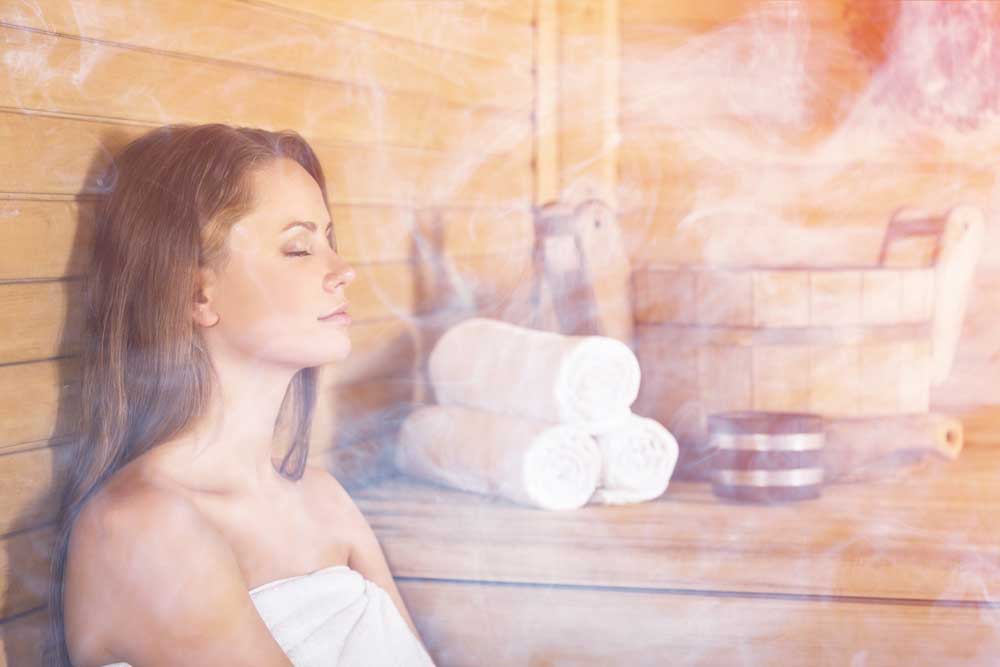 A woman sitting in a sauna 