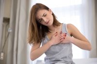 young woman have a heart attack because of cardiovascular diesease