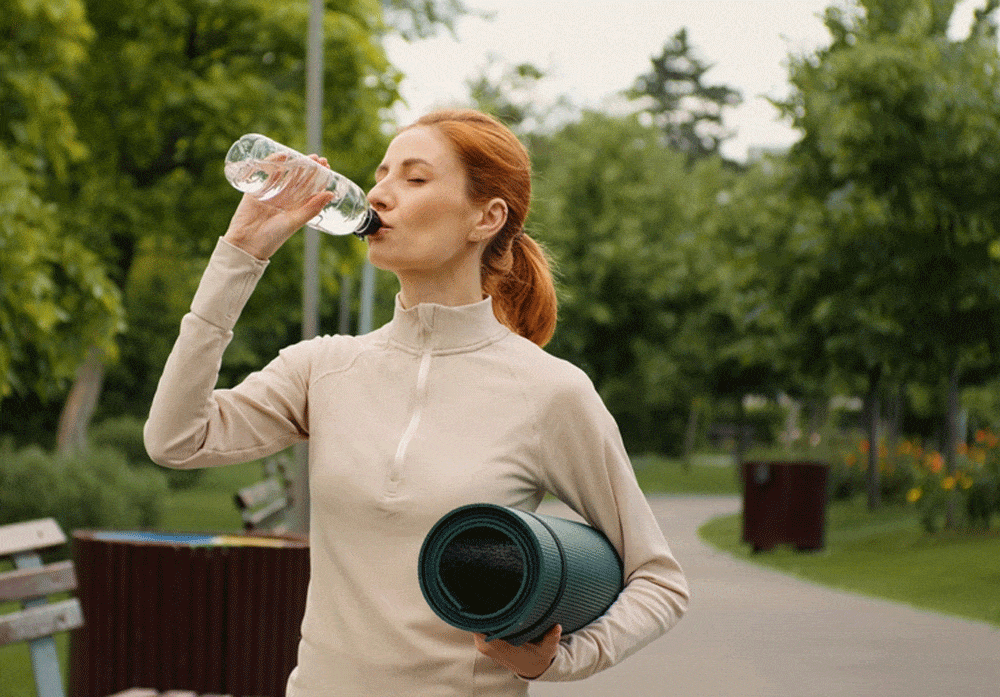 Drinking water from a plastic water bottle